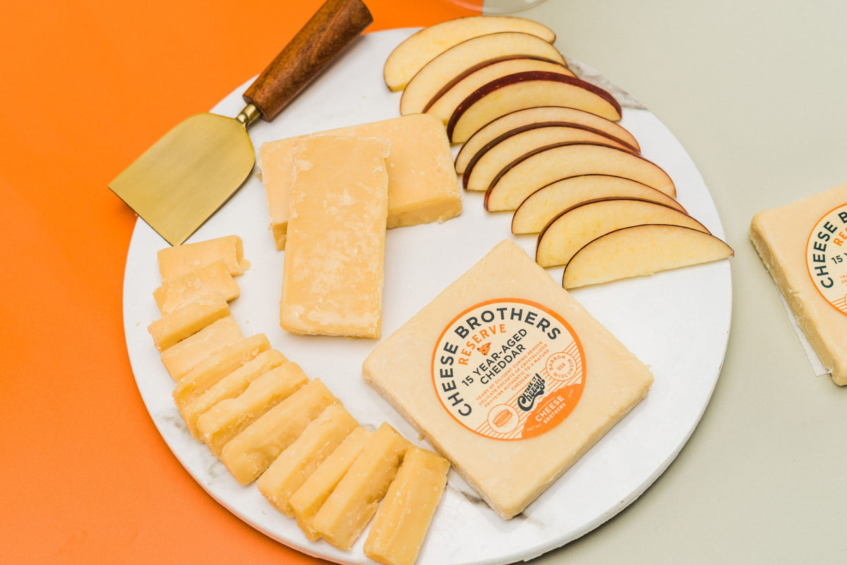 Package of 15-year aged Wisconsin cheddar on a charcuterie board.