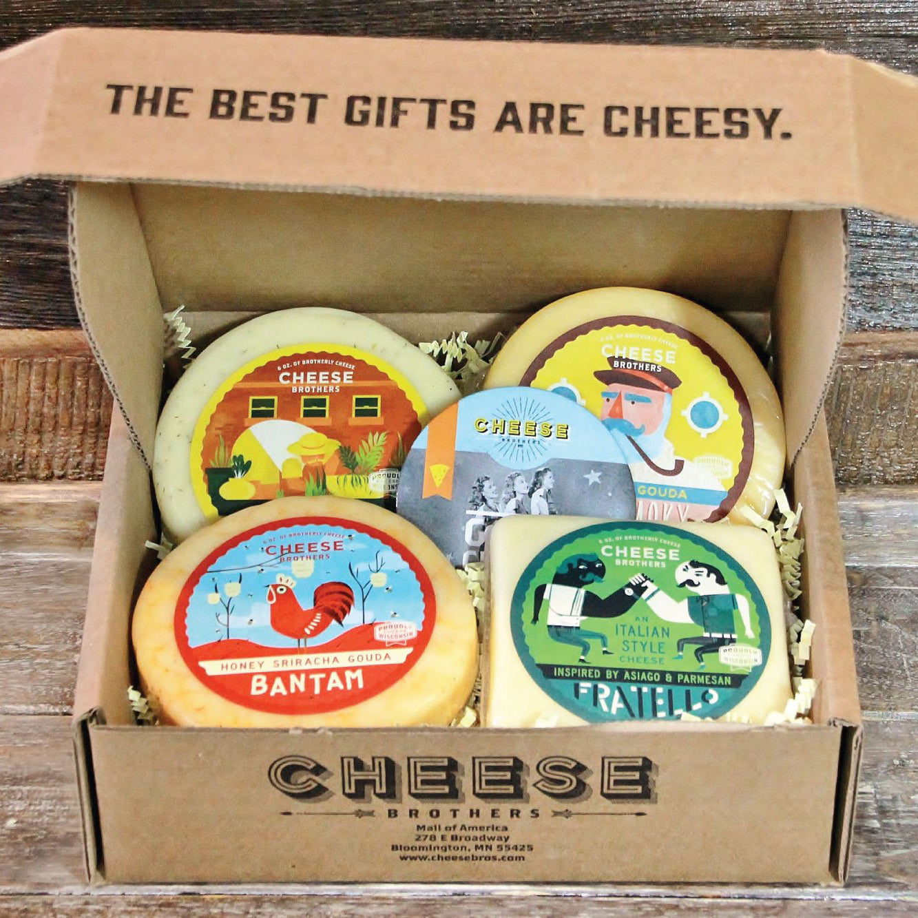 Cheese Brothers sampler box with sriracha gouda, Italian style cheese, and 3 other cheeses. 