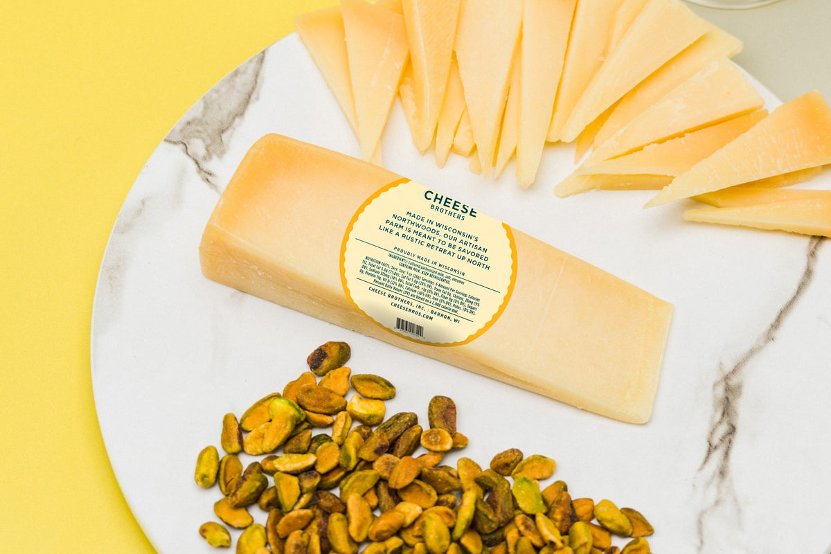 Back of package for Cheese Brothers gourmet parmesan with description and ingredients label on charcuterie board.