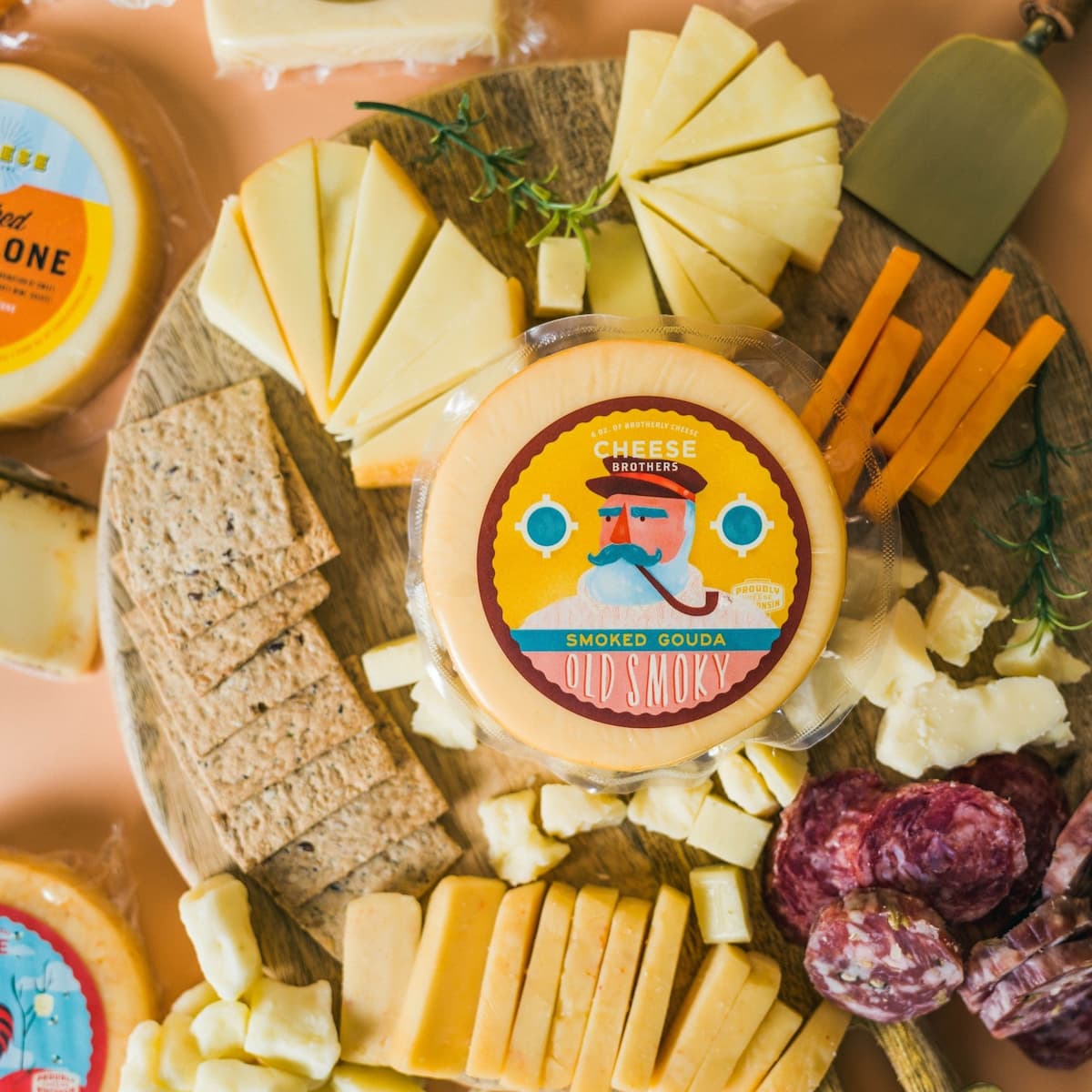 Cheese Brothers 'Old Smoky' smoked gouda cheese sat on top of a platter of accompaniments.