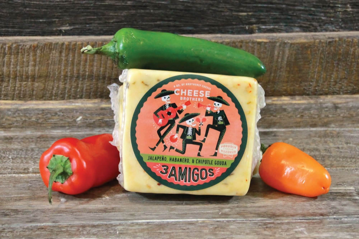 Package of 3 Amigos spicy Wisconsin Gouda surrounded by peppers. 