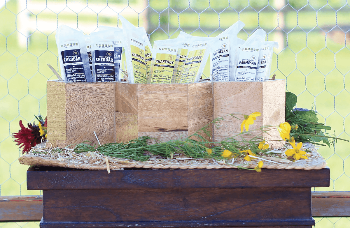 Three boxes each with a different variety of gourmet cheese sticks. 