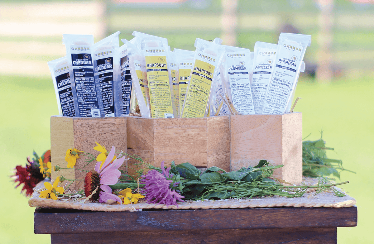 Three boxes each with a different variety of gourmet cheese sticks. 