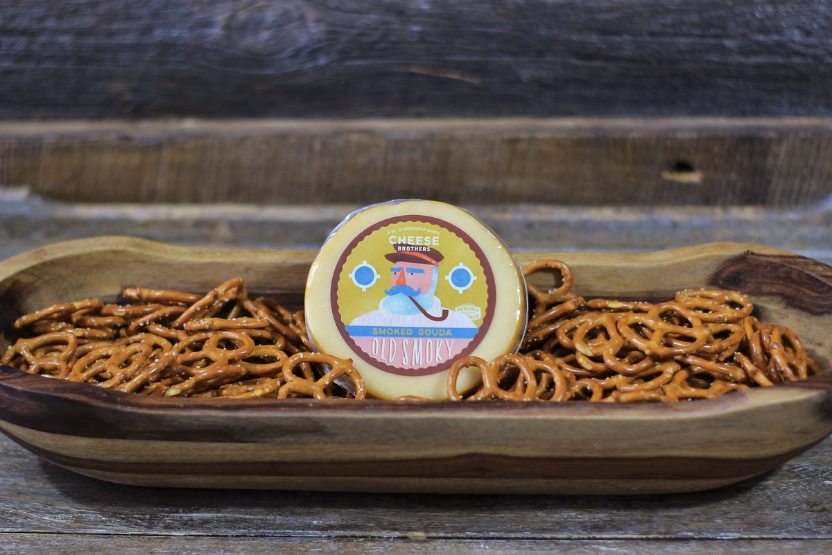 Package of Old Smoky artisan smoked gouda in a bowl of pretzels. 