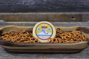 Package of Old Smoky artisan smoked gouda in a bowl of pretzels. 