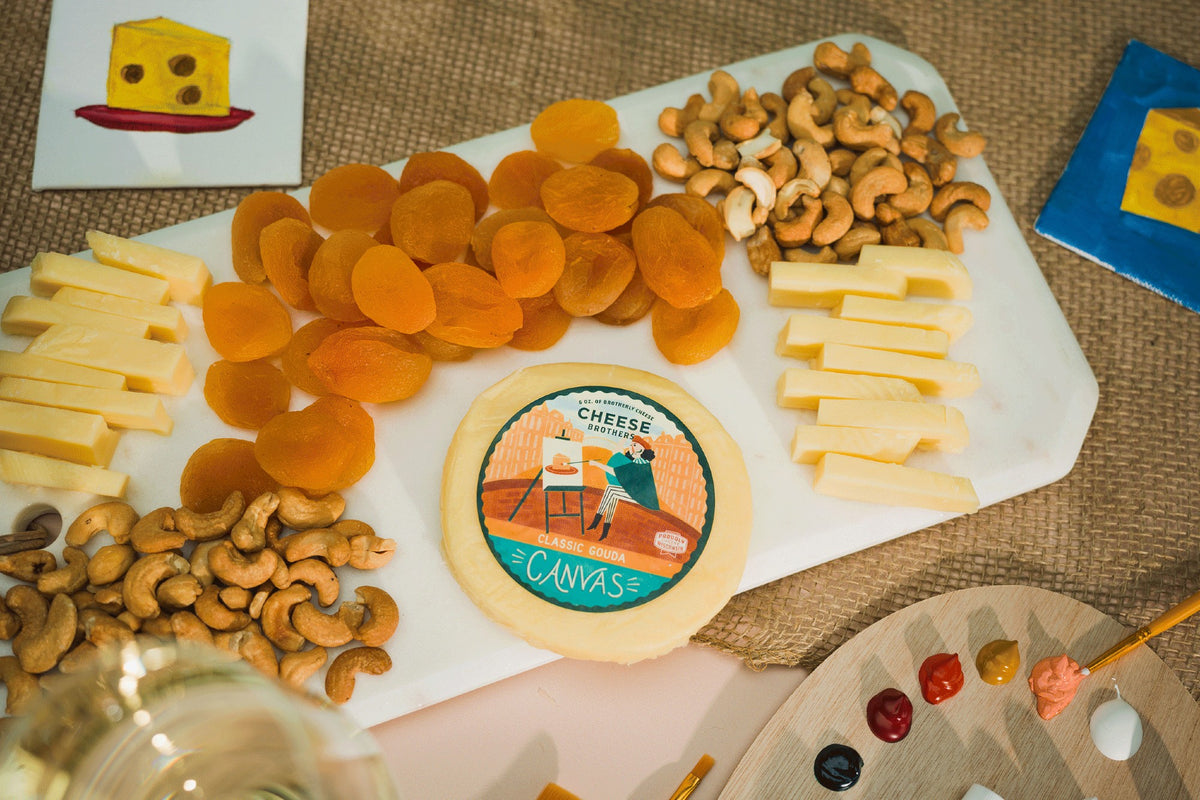 Package of canvas gouda on a white charcuterie board. 