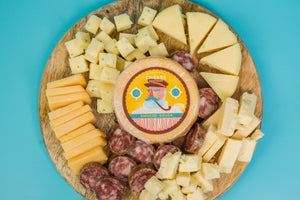 Package of Old Smoky artisan smoked gouda on a charcuterie board. 
