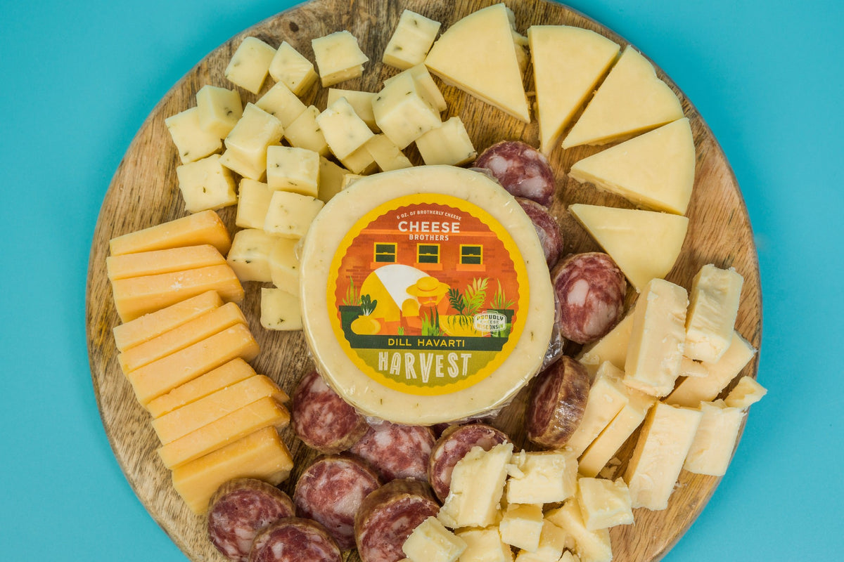 Package of dill Havarti Harvest artisan cheese on a charcuterie board.