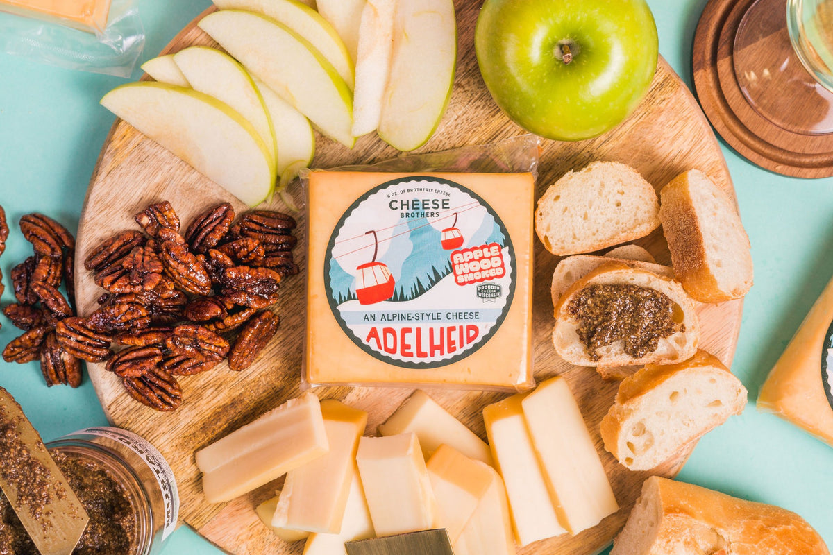 Package of Adelheid alpine-style cheese on a charcuterie board. 