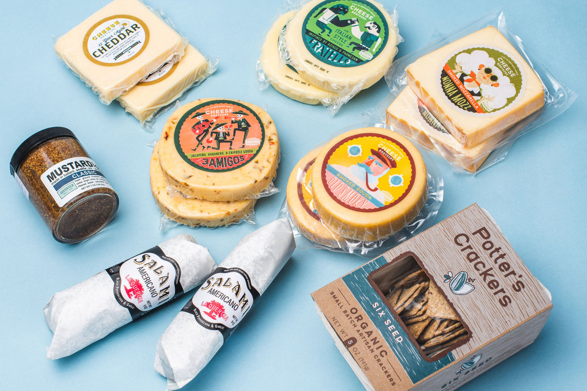 Ten packages of five different varieties of gourmet Wisconsin cheese with organic crackers, two salamis, and mustard. 
