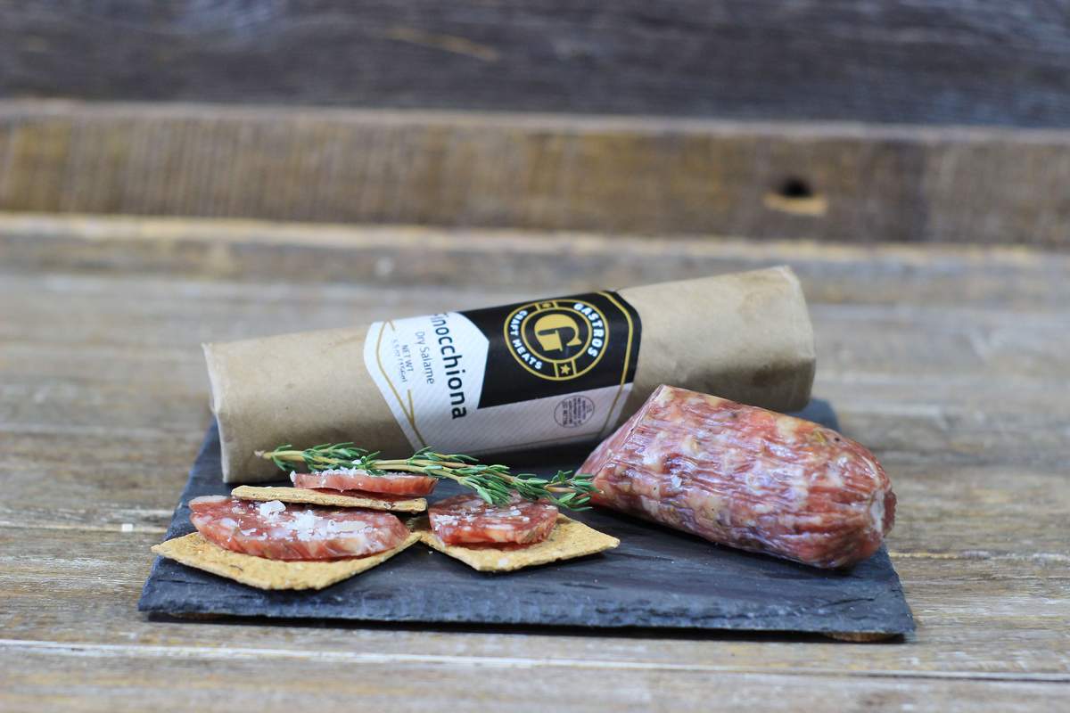 Package of Finocchiona with slices on crackers. 