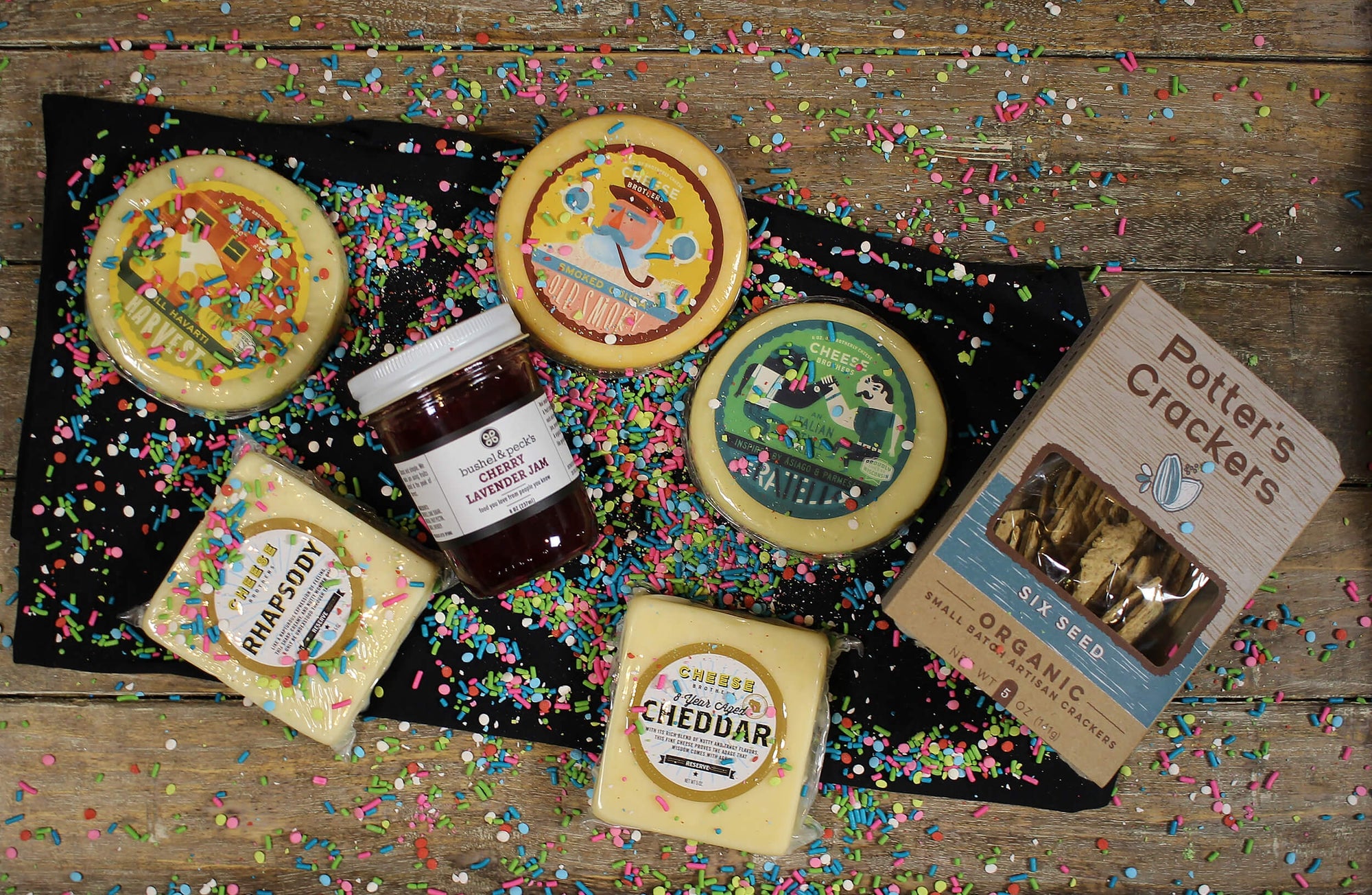 Retirement gift box with five varieties of gourmet cheese, organic crackers, and jam. 