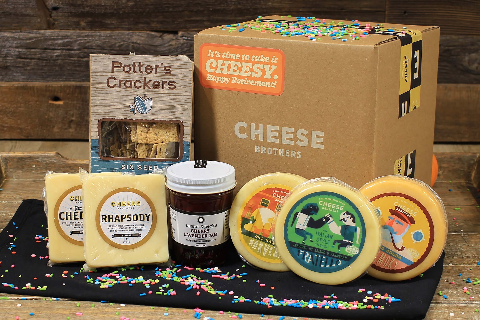 Retirement gift box with five varieties of gourmet cheese, organic crackers, and jam. 