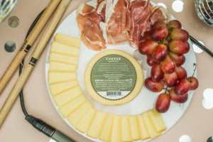 Back of package for Cheese Brothers smoked provolone on a charcuterie board. 